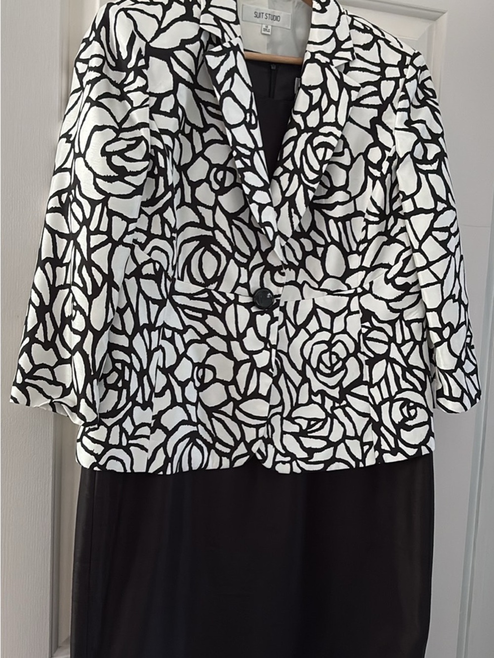 Black Sleeveless Dress with a Black and White 3/4 Sleeve Jacket